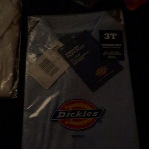 Two new 3T Polo style shirts, one blue, one white still in packaging with tags.